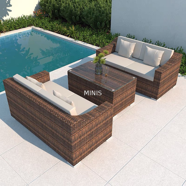 Sof&aacute; de mimbre marr&oacute;n para jard&iacute;n al aire libre con mesa de cristal